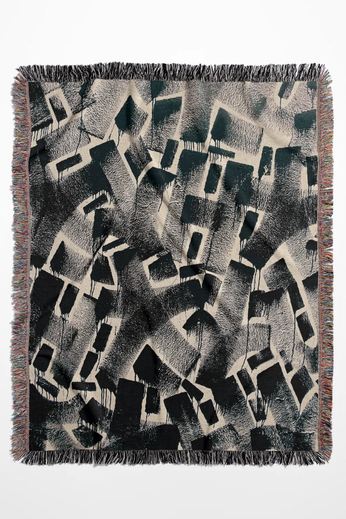 Charcoal geometric cotton throw blanket with modern industrial design.