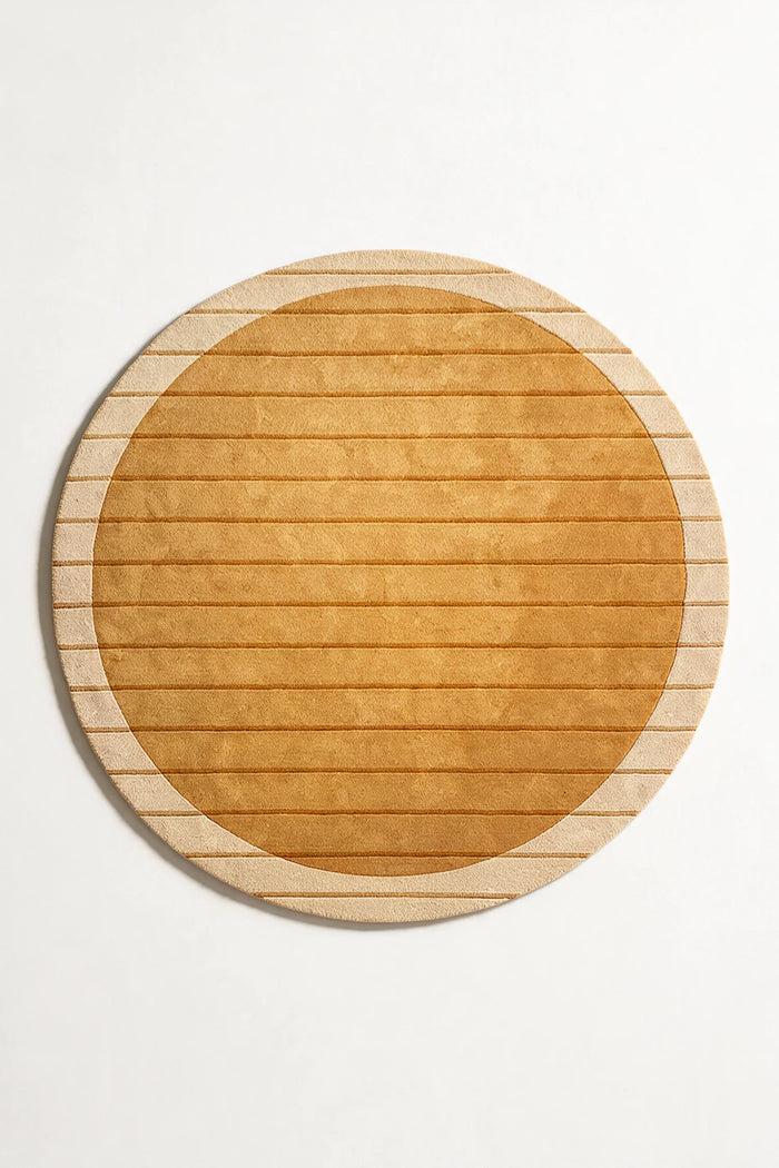 Golden yellow round wool rug with subtle striped carving, perfect for dining rooms, bedrooms, or cozy modern spaces