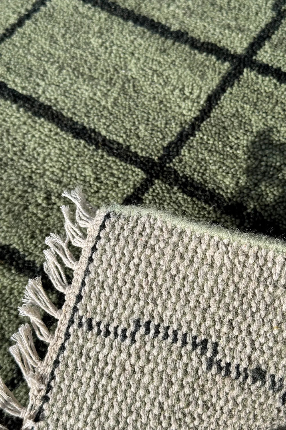 Modern grid wool rug in sage green, featuring natural fringe, available in 5x5 and 6x6 sizes