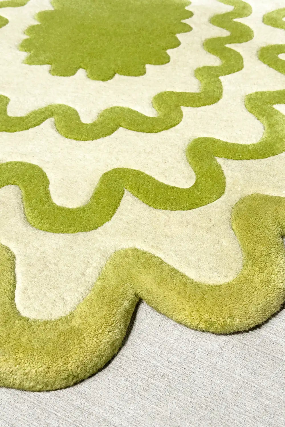 Close-up of lime green and ivory wavy wool rug showing plush hand-tufted texture, colorful and contemporary.