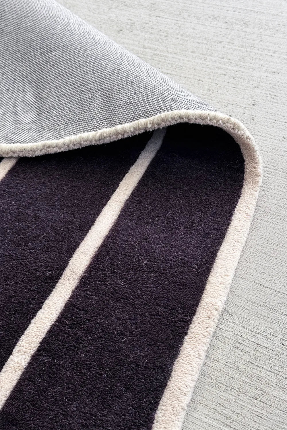 5x7 art deco wool rug with black base and white stripes for a living room or bedroom