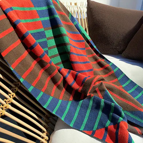 Striped knit throw in bold blue, green, and red tones, perfect as a colorful bed blanket or vibrant throw for reading nooks