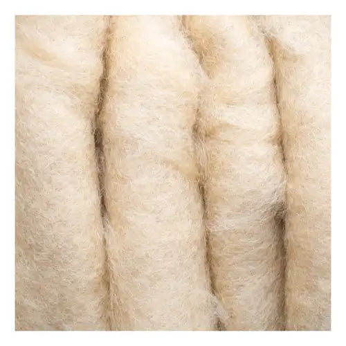 A close-up of raw, unprocessed wool fiber in soft off-white, highlighting the natural material used in handmade rugs.