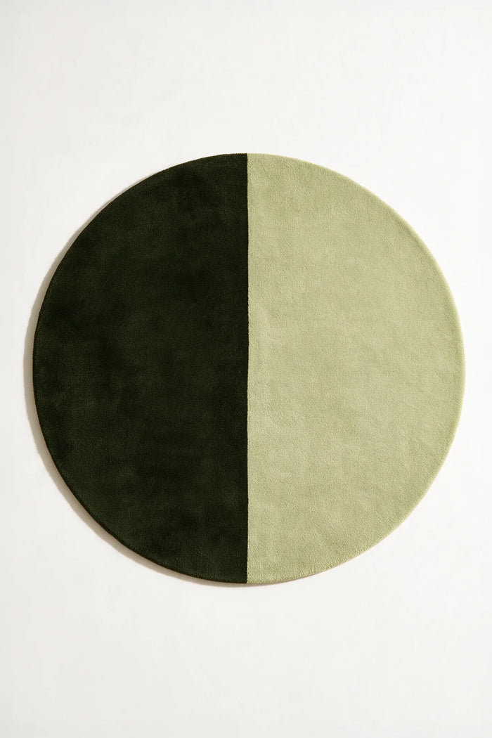 Two-tone green modern wool round rug, designed for mid century spaces, minimalist bedrooms, or cozy living rooms olive