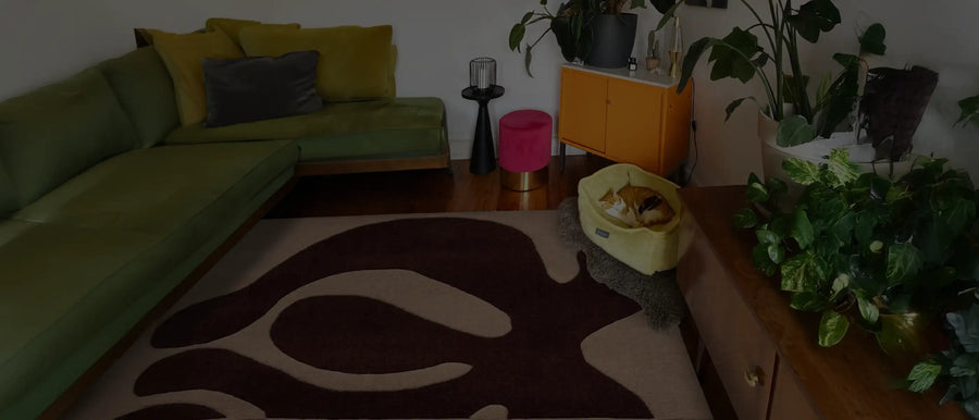 Living room with a retro-inspired brown and cream abstract rug, styled with eclectic furniture and a cozy ambiance.