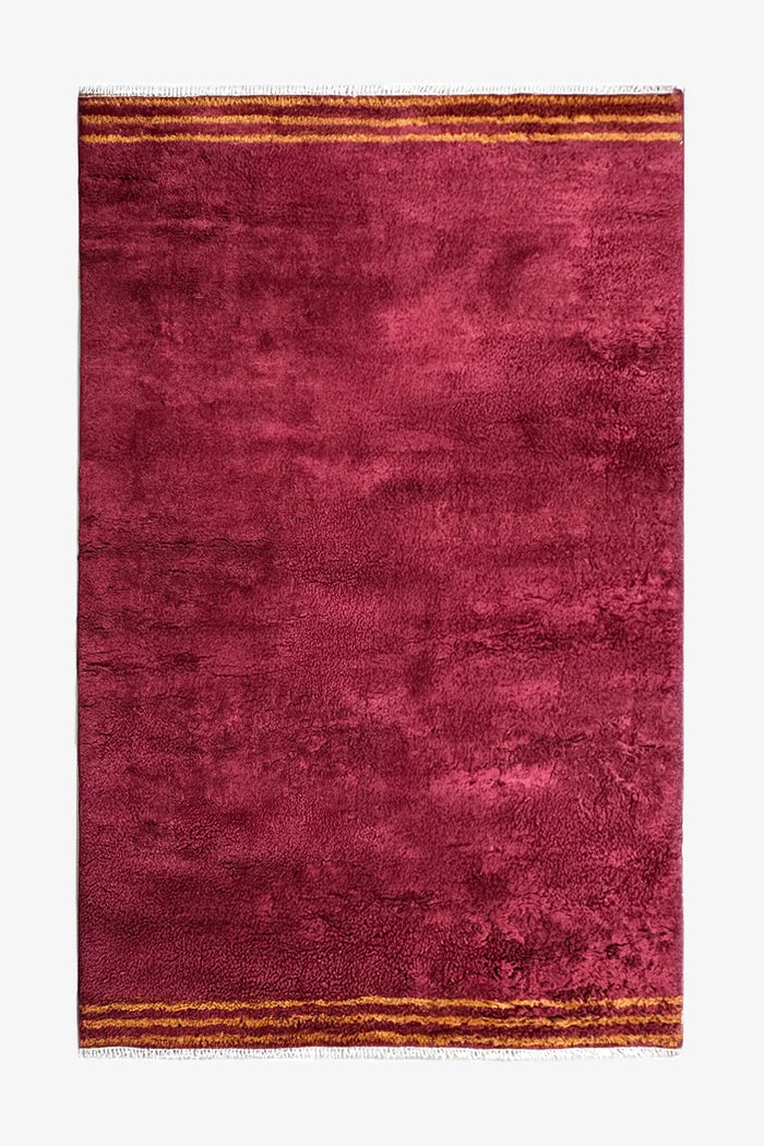 8x10 plush red shag rug with golden striped ends and hand-knotted fringe, perfect for modern or bohemian living rooms
