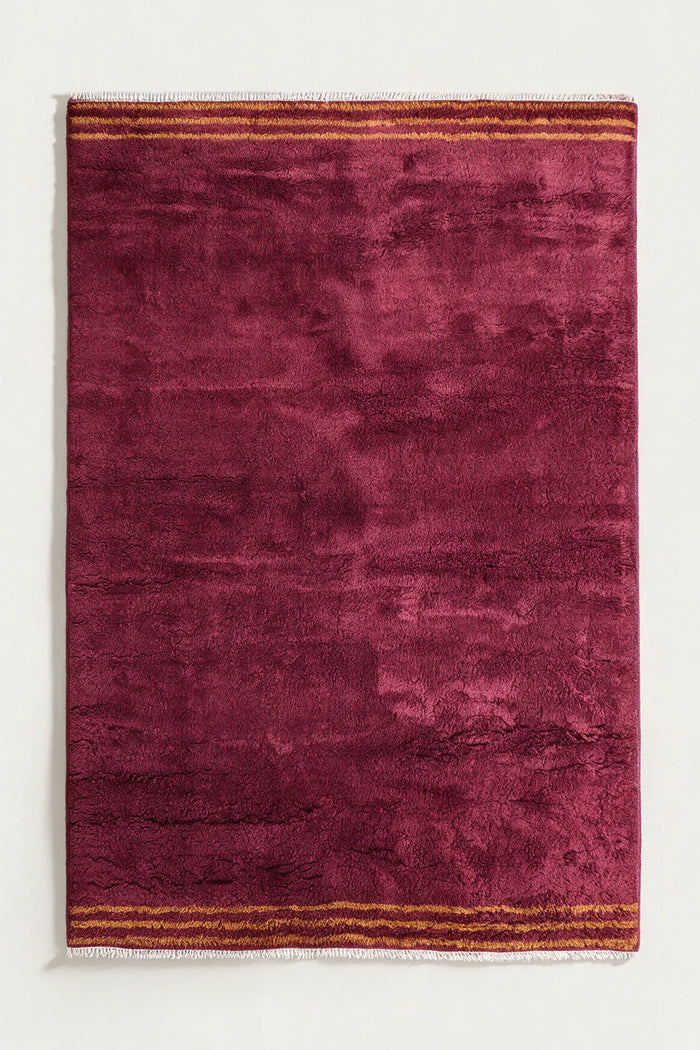 8x10 plush red shag rug with golden striped ends and hand-knotted fringe, perfect for modern or bohemian living rooms