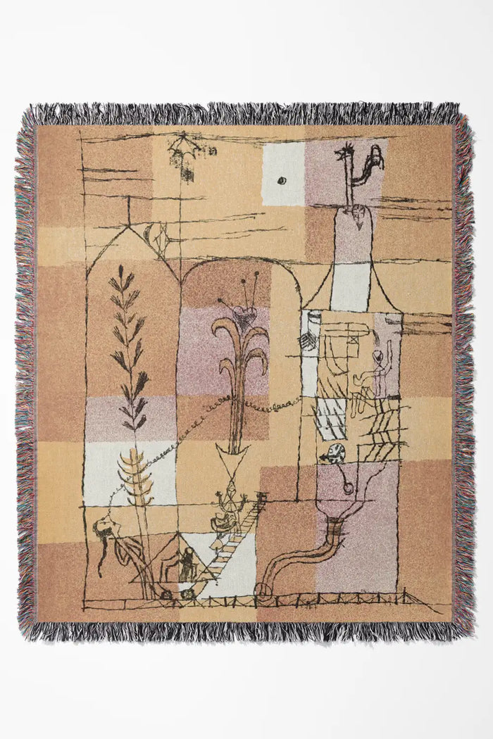 Golden yellow and burnt orange tapestry throw blanket with artistic detailing and colorful fringe.