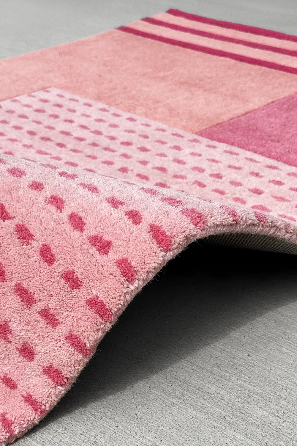 Pink geometric wool rug with retro dot pattern and soft plush pile, perfect for kids rooms and nursery