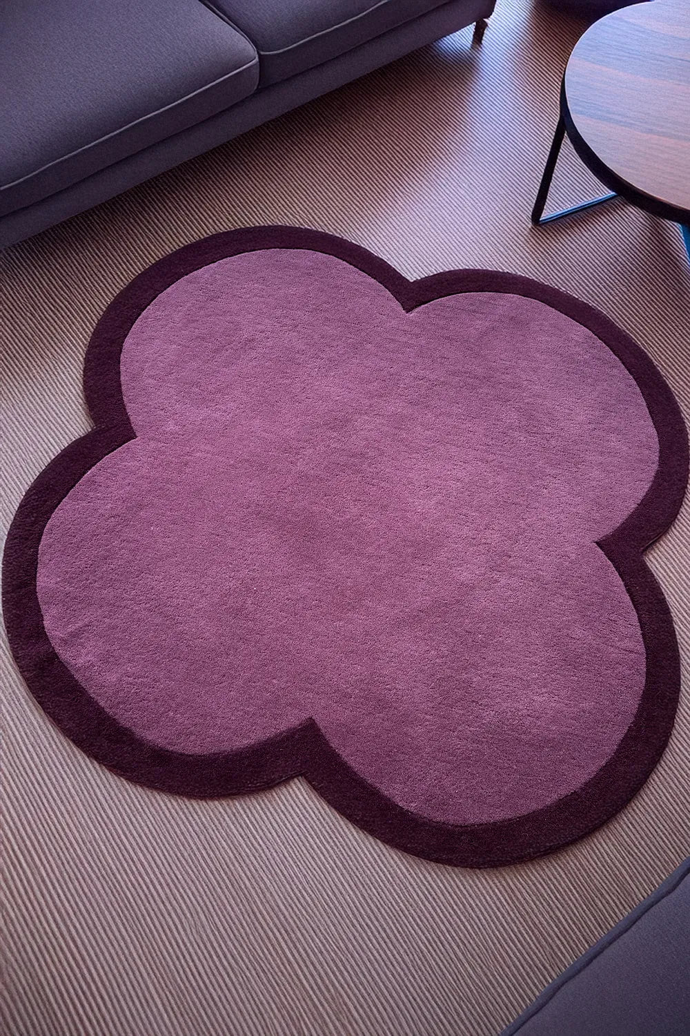 10x10 purple retro rug in a modern living room, an abstract flower shaped rug that adds bold pop to neutral space