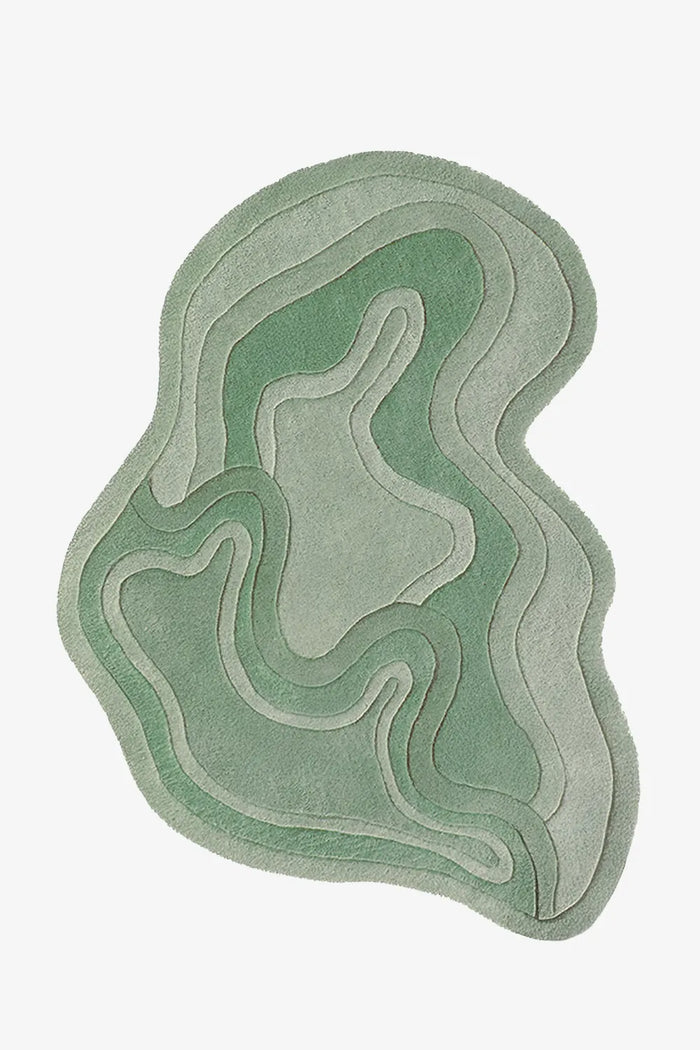 Sage green irregular rug with fluid contours, perfect as a modern wool rug for living room, kids area rug, or boutique neutral area rug
