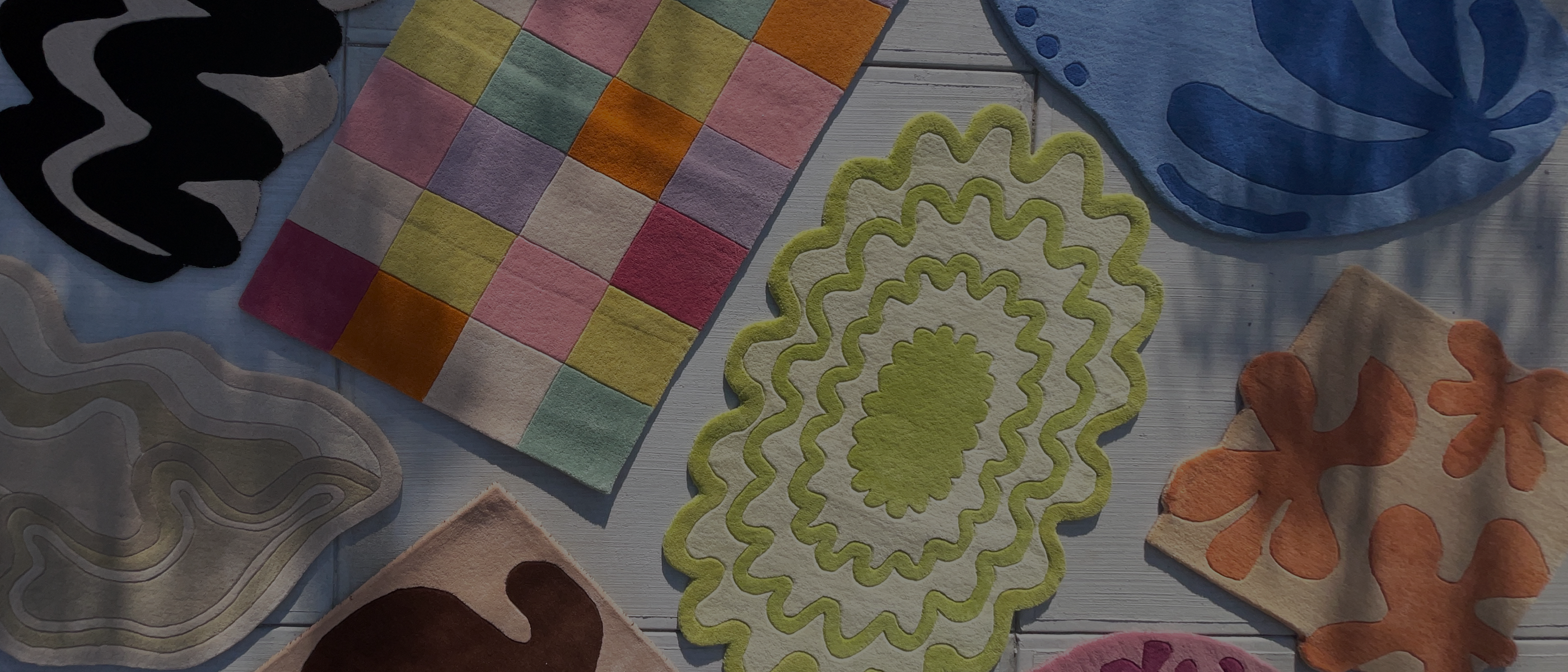 jubi rugs unique colorful rugs arranged in a sunny room highlighting their sculpted patterns and vibrant colors