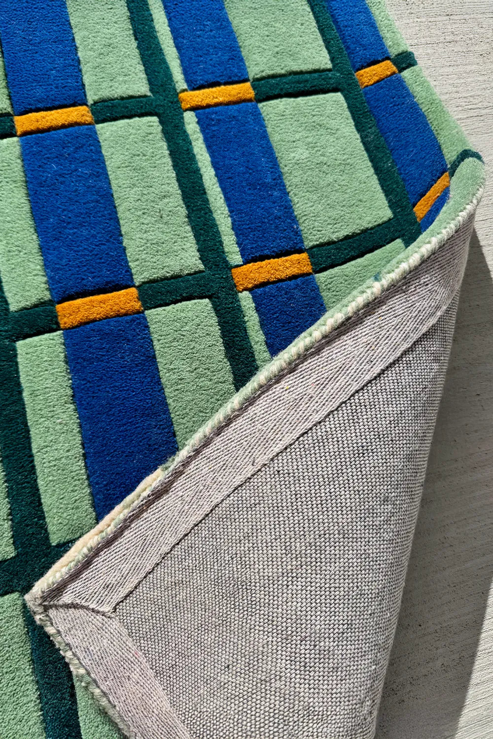 Retro-inspired multicolor modern area rug with structured checkered grid design