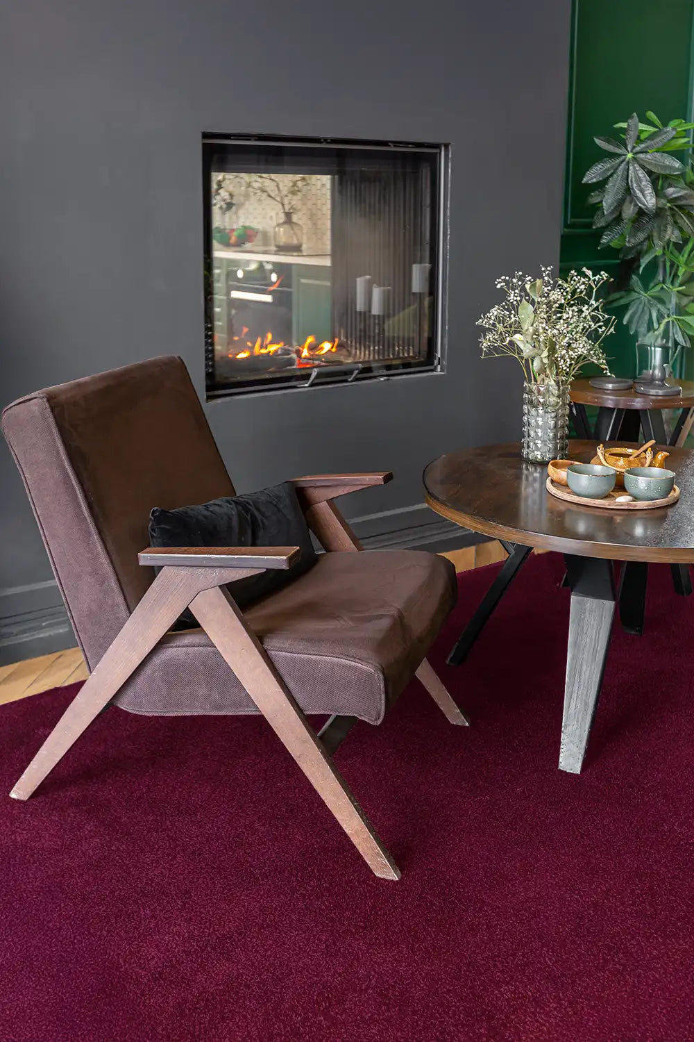 Large rich burgundy red wool rug adding warmth to a contemporary living room.