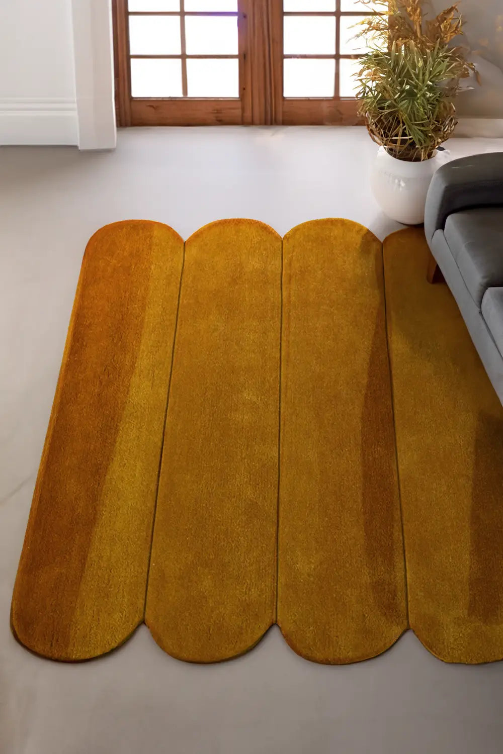 9x12 golden yellow wool area rug with rounded edges styled in bright modern living space