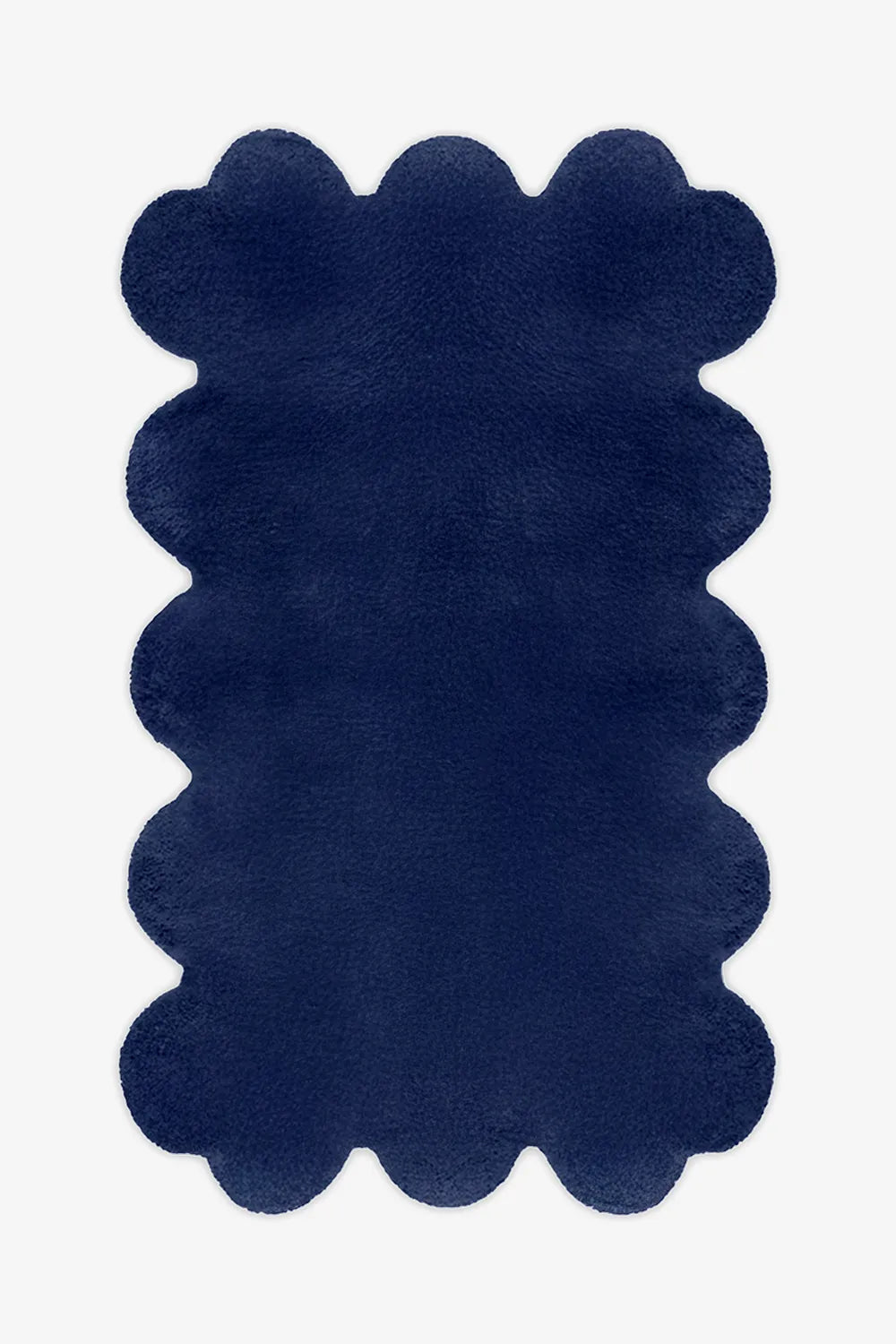 Modern navy blue scalloped rug with soft wool pile and bold sculpted edges, ideal for moody interiors