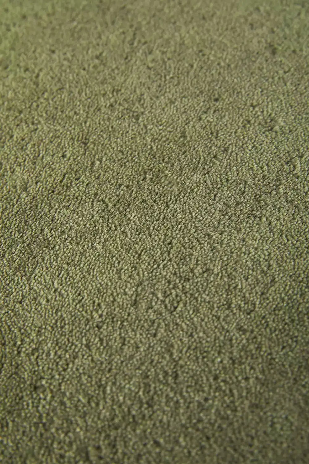 Olive green wool rug with plush modern pile and soft, sculptural rounded edges