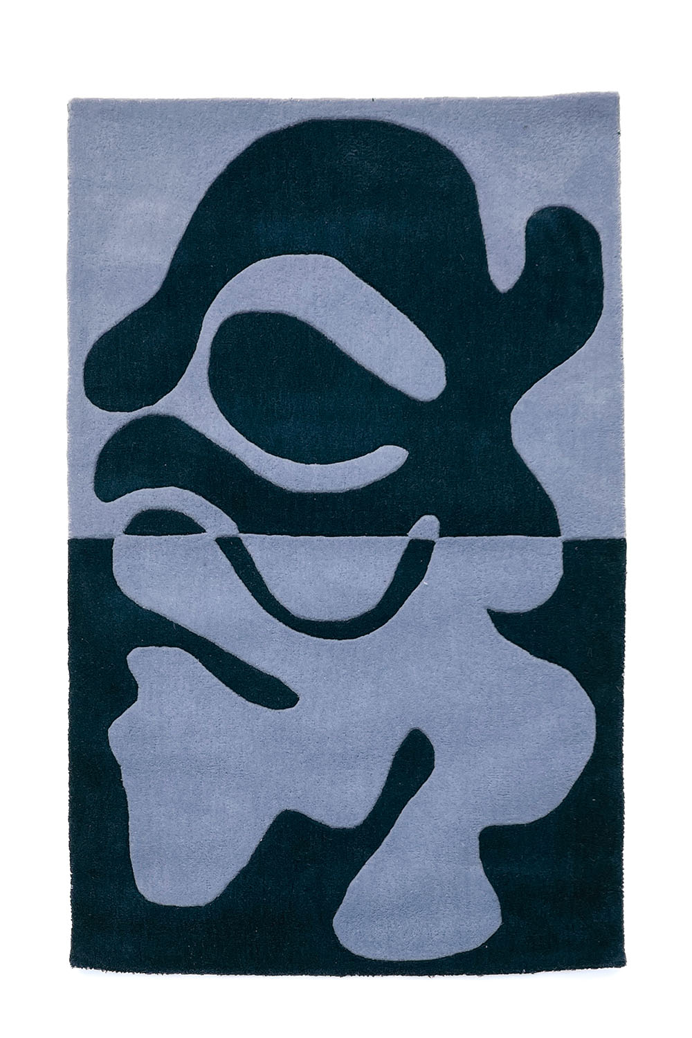 Tufted wool rug with navy and sky blue split-tone abstract composition