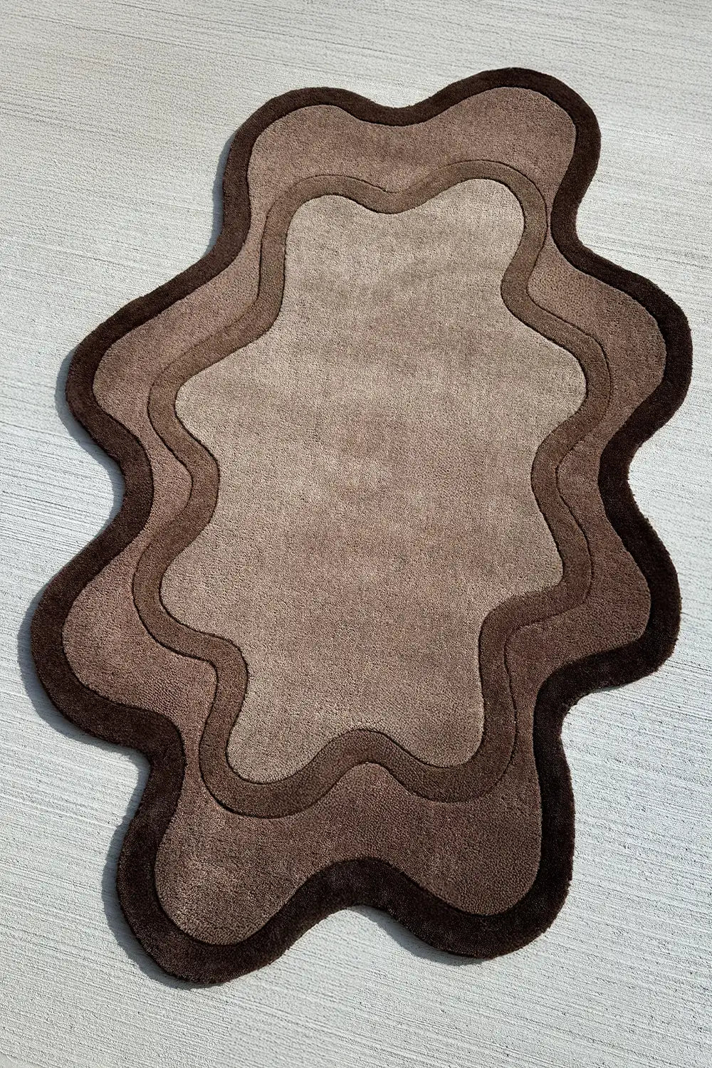 Tufted modern wool rug with abstract ripple shape in dark and light brown tones for Japandi or minimalist interiors