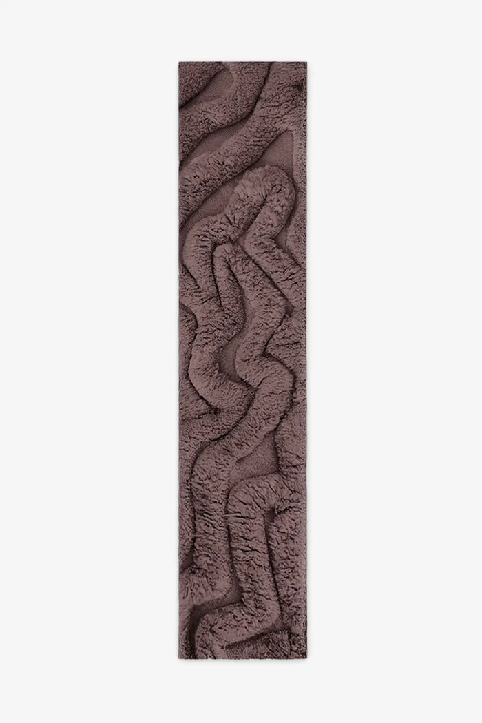 Hand-tufted brown runner rug with a sculptural, high-pile design featuring organic, wavy textures for a plush and modern aesthetic.