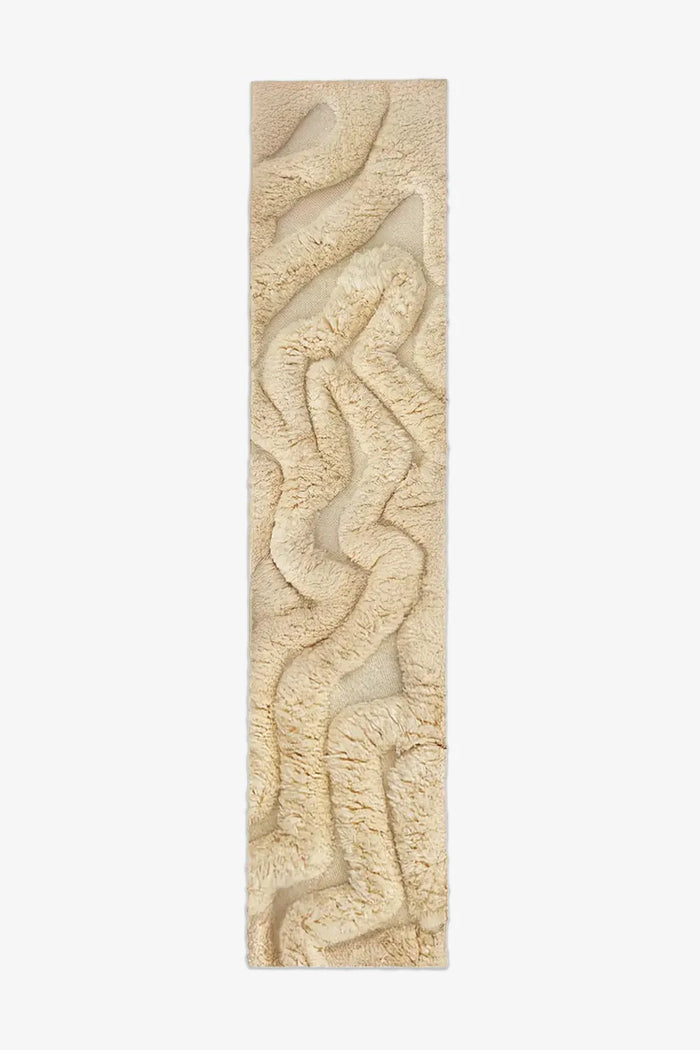 Hand-tufted tan cream-colored runner rug with a sculptural, high-pile design featuring organic, wavy textures for a plush and modern aesthetic.