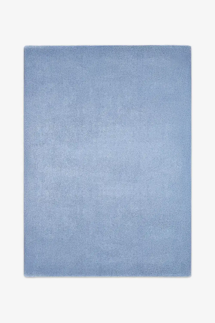 Soft light baby blue wool area rug sized 6x9, a serene option for modern living rooms, bedrooms, or nursery designs