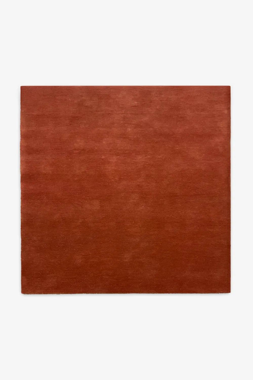 Rich burnt orange wool square rug available in 8x8 and 10x10 sizes, bold choice for boho rugs and large living rooms