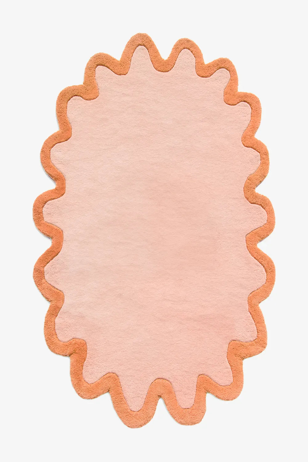 Modern peach round wool rug with orange scalloped border, available in 5x8 and 8x10