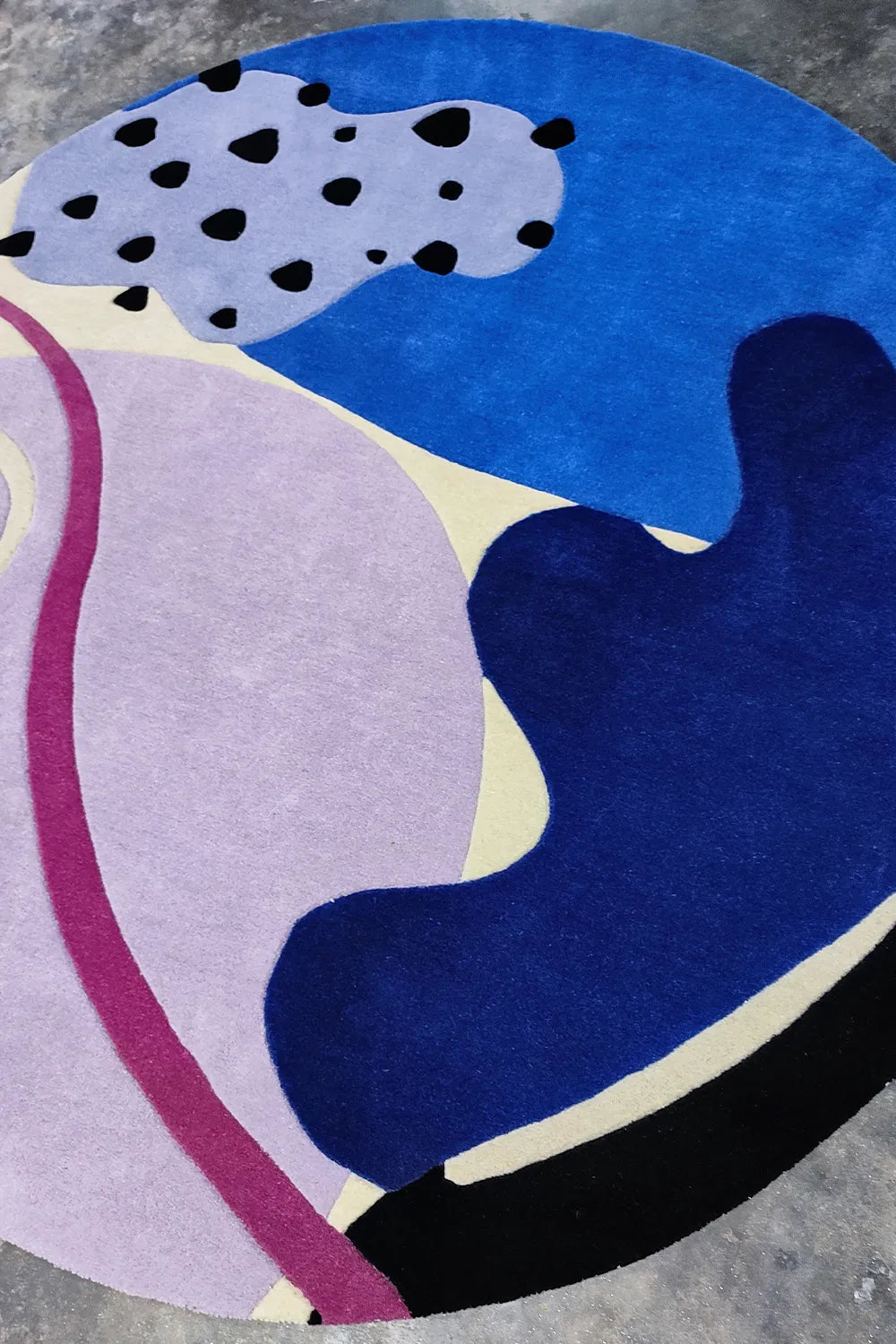 Playful black and white spotted motif on funky purple and blue circle rug