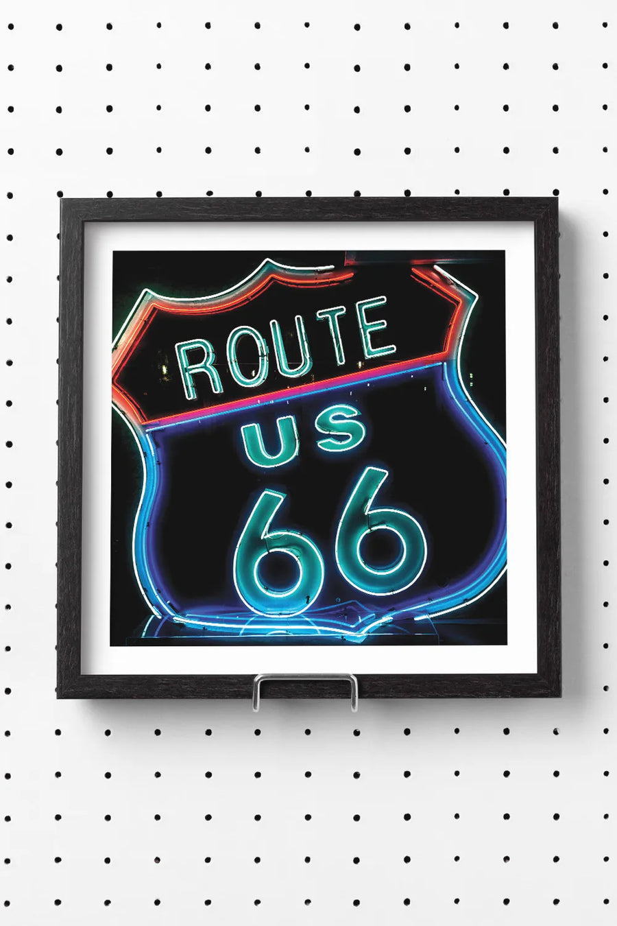 Neon Route 66 sign glowing in red and blue against a dark background