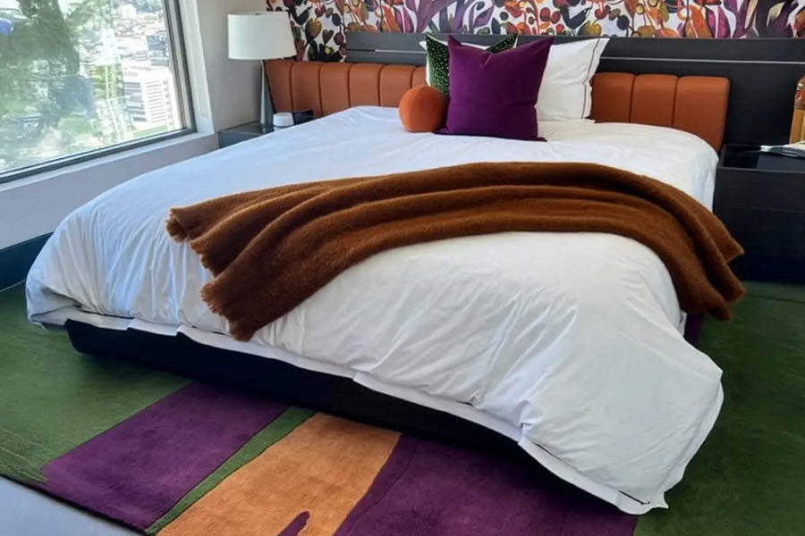custom made rug in green purple and orange wool in a modern colorful bedroom