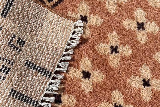 close-up detail of knot density in a modern hand-knotted wool rug in neutral geometric pattern with fringe