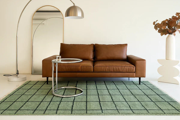 green and black checkered wool area rug in a modern minimalist living room