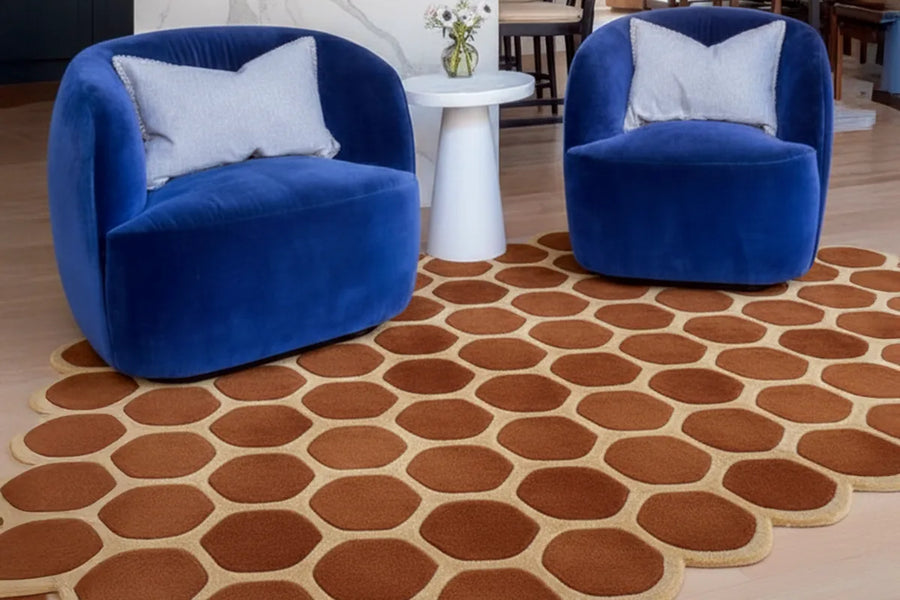 unique honeycomb patterned rug with irregular shape in a modern living room with blue chairs