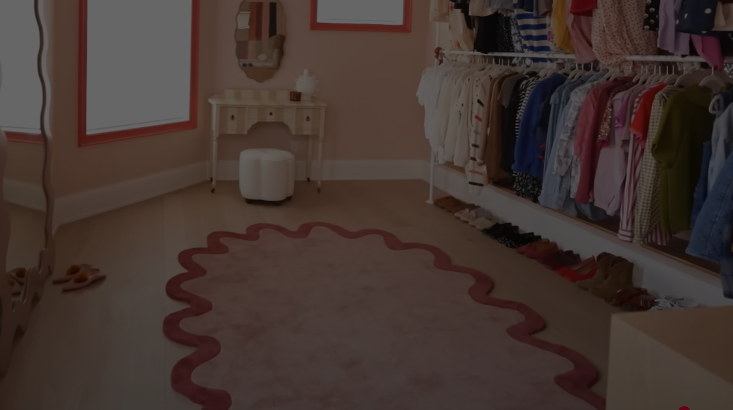 dream closet makeover featuring the Halo Burst Oval Tufted Rug in soft pink with a deep rose scalloped border, adding warmth and texture to the stylish dressing space