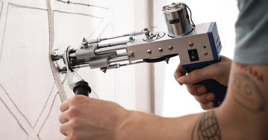 craftsman with tufting machine making pattern on carpet