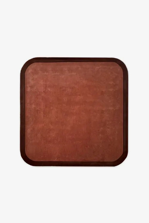 square wool rug in brown with dark contrast border