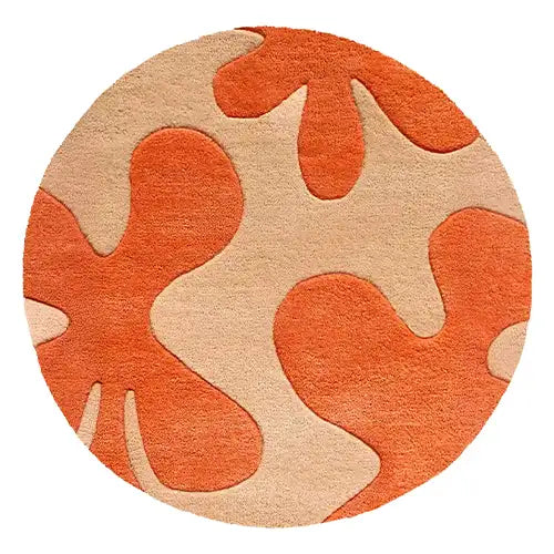 orange and tan round wool rug with modern abstract floral design