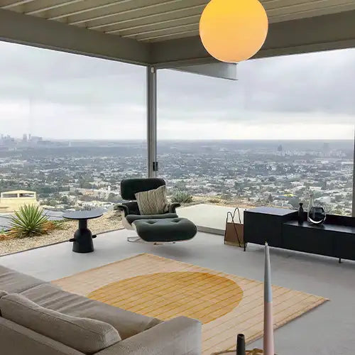 neutral gold and tan area rug in an airy contemporary living room with a japandi aesthetic