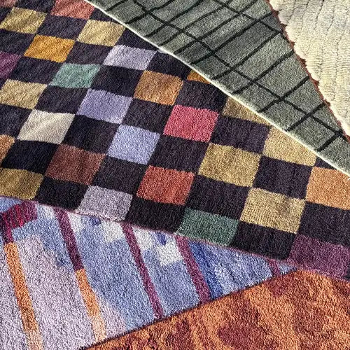 Large hand-knotted area rugs in bold colors for a spacious living room.