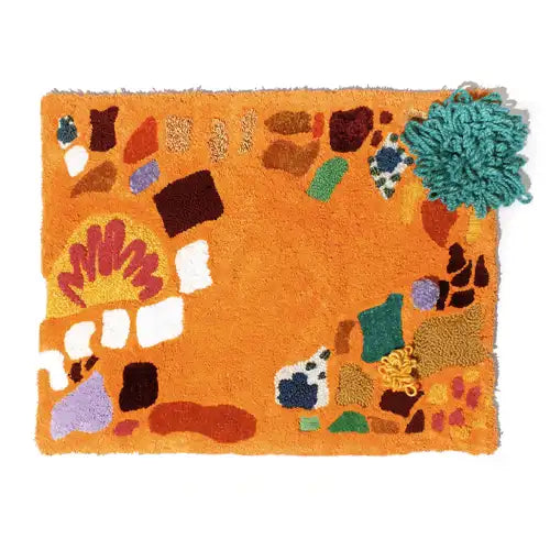 orange handwoven wall hanging with mosaic pattern