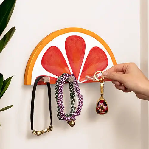 modern key holder for wall with a ceramic blood orange fruit slice shape design