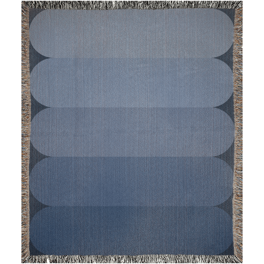 Minimalist cotton throw blanket with a soft blue color gradient.
