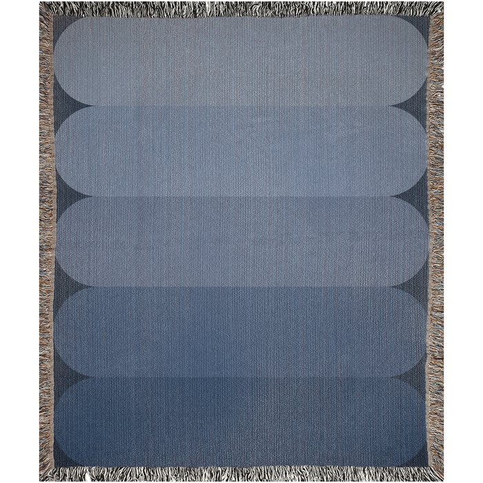 Minimalist cotton throw blanket with a soft blue color gradient.

