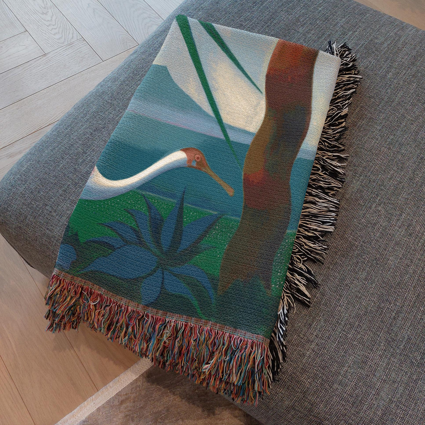 Blue scenic woven throw blanket with a tropical nature-inspired design.
