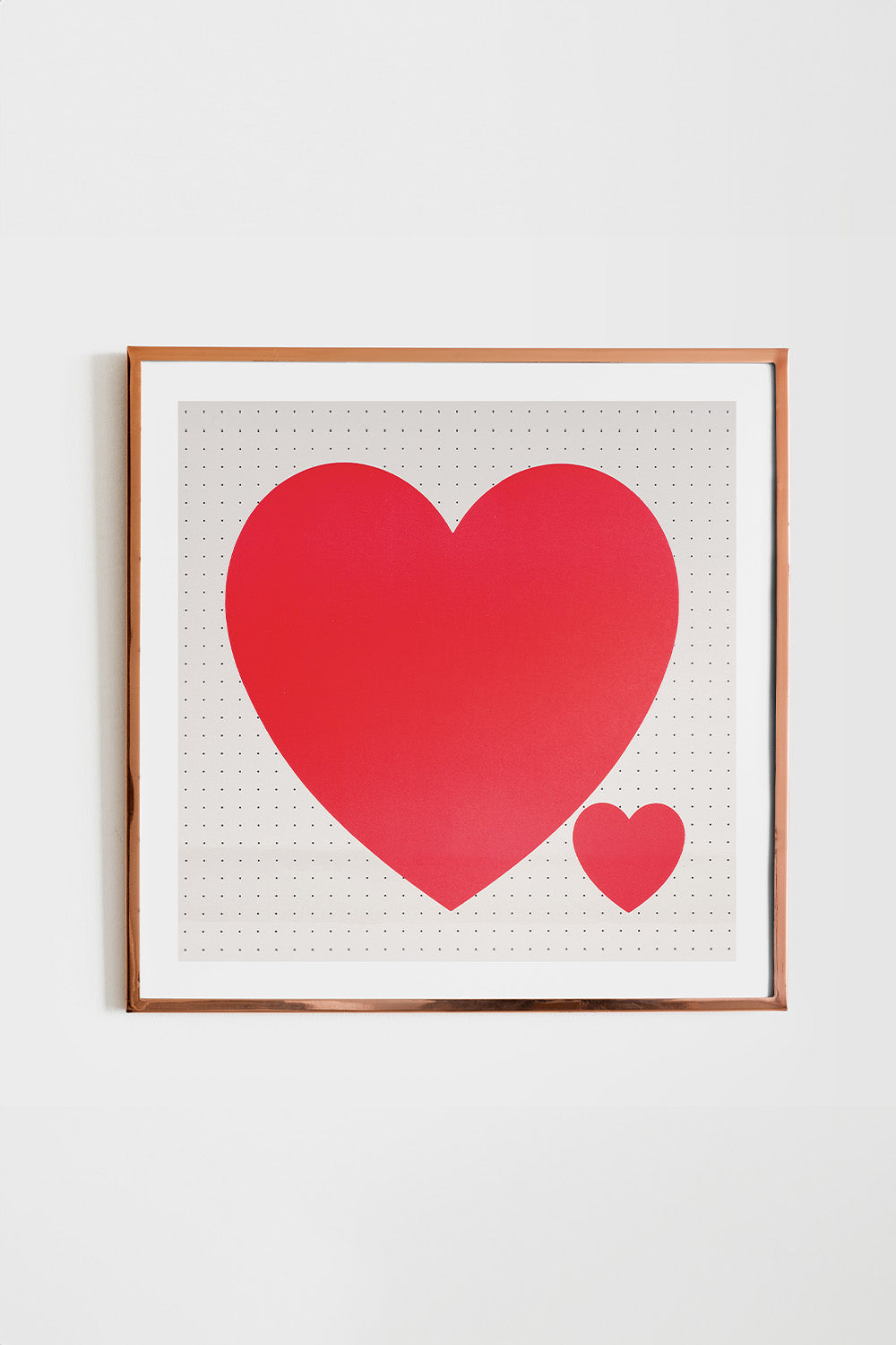 Bold square art print of large and small red hearts on a dotted graph paper background.