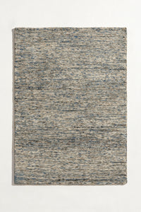 a flint hand-tufted wool rug with heathered grey, blue and sand flecks shown from above