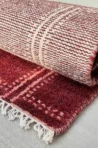 deep red graphic wool area rug with modern geometric design