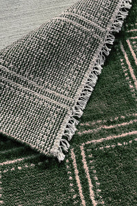 Green handmade wool rug with structured box design, perfect for modern interiors