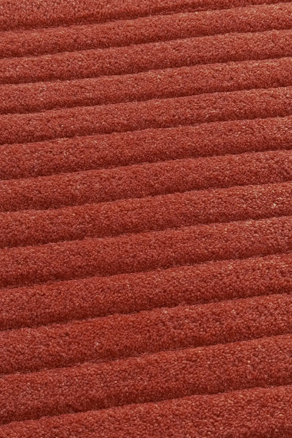 Close-up of the Ridge Duo Rug's textured ridges in terracotta 